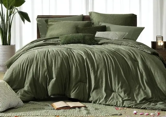 Monbix Queen Comforter Set in Olive Green displayed on a neatly made bed with matching pillowcases and shams – a cozy and elegant green bedding ensemble.